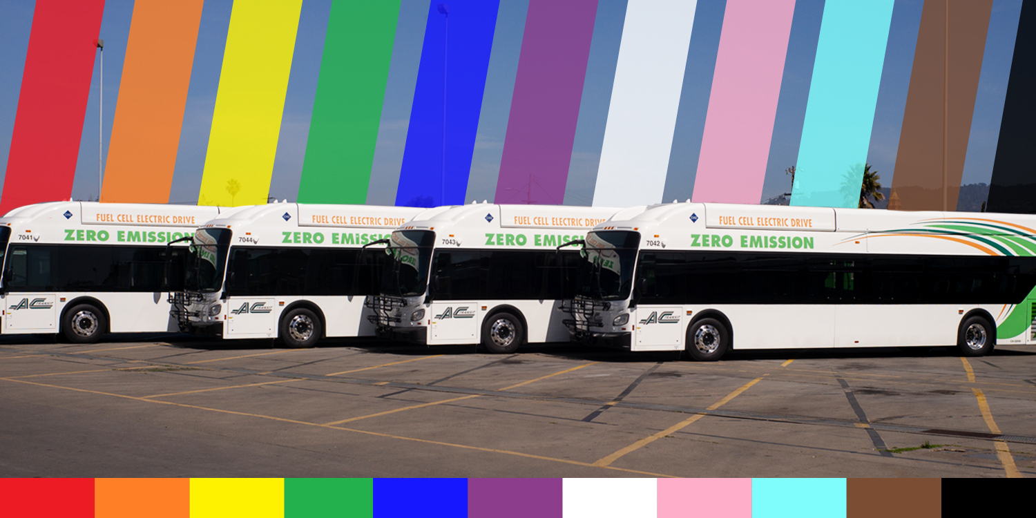 AC Transit buses with the Pride flag colors in the background