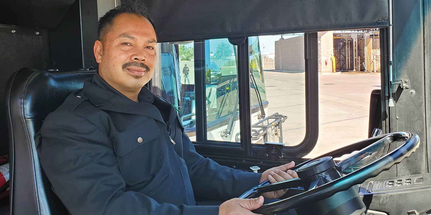 BUs operator, smiling and looking into the camera