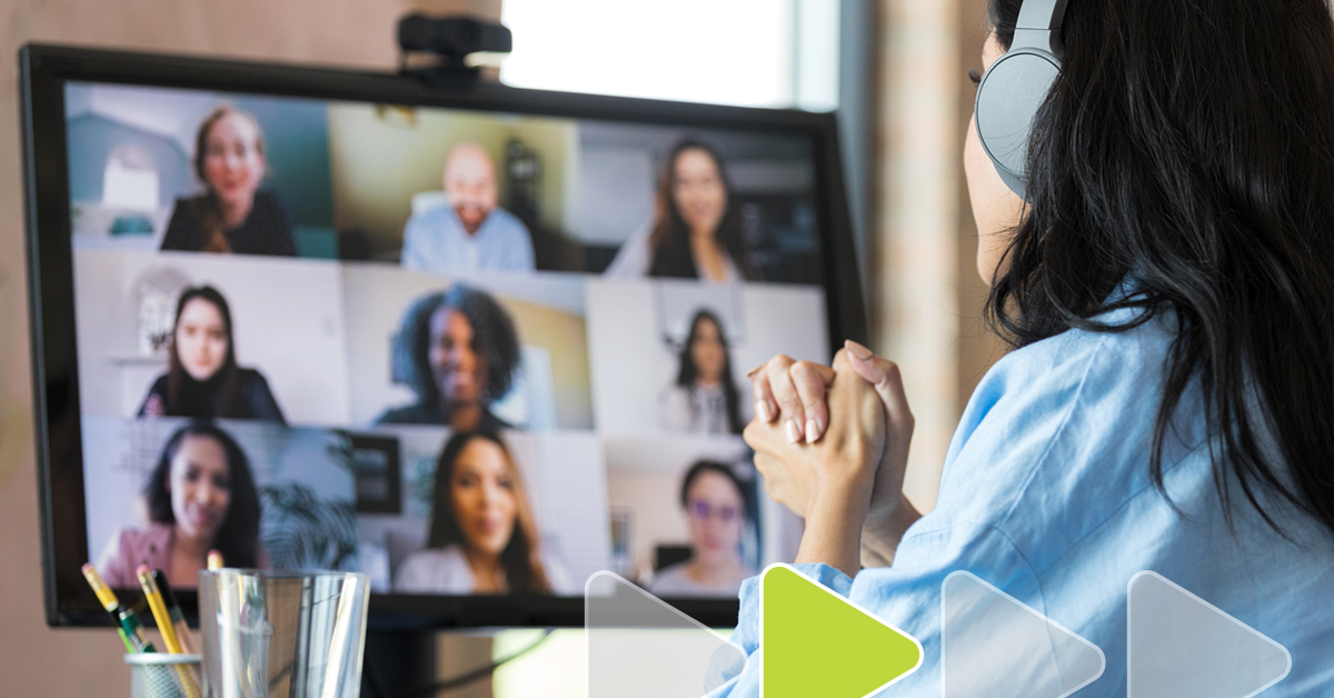 Woman looking at computer screen during video call; nine faces on screen