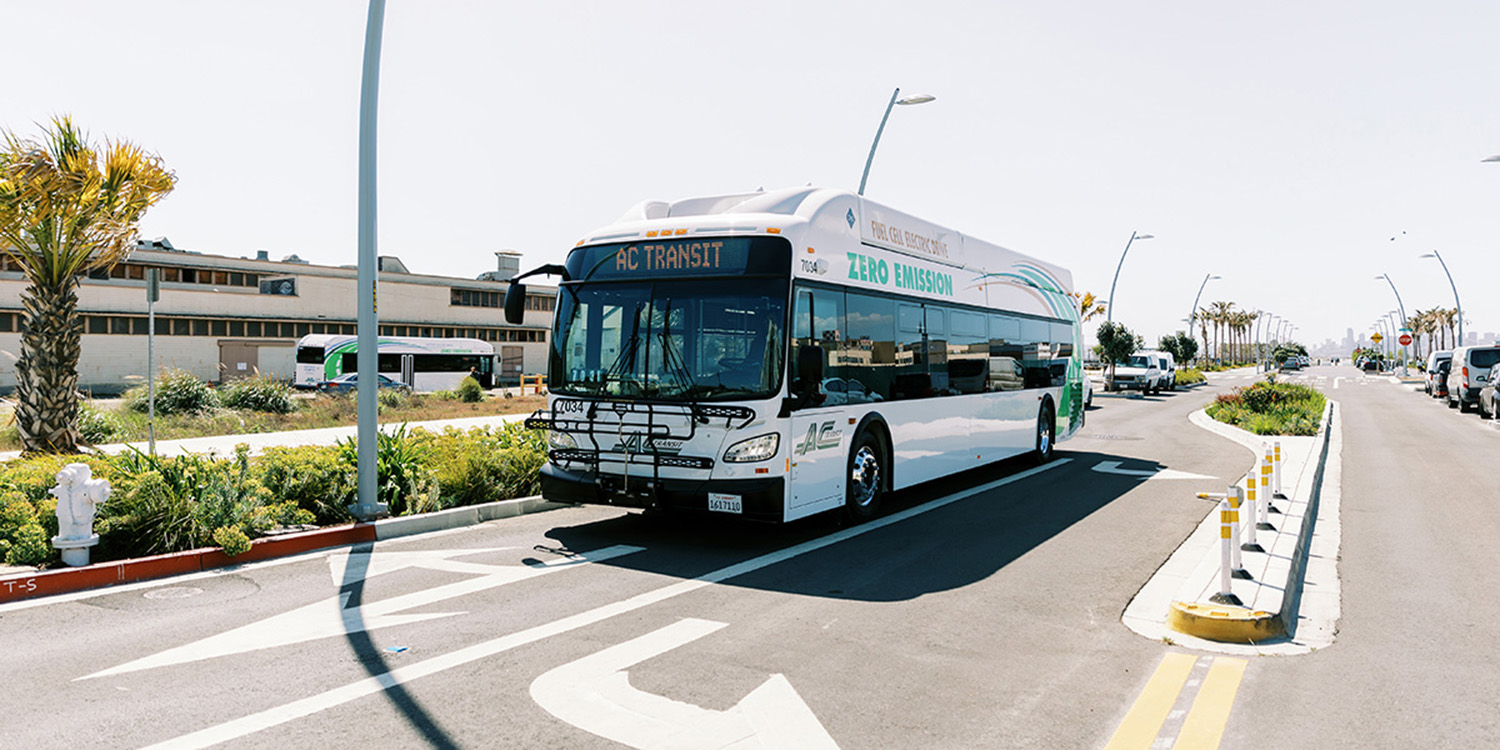 AC Transit bus driving down empty street