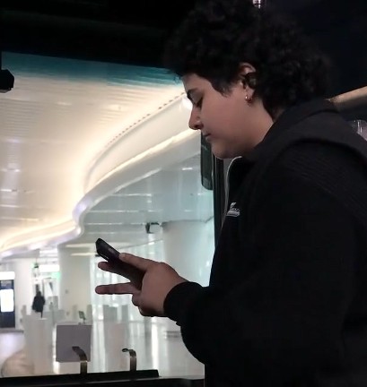 Scheduler holding phone on bus