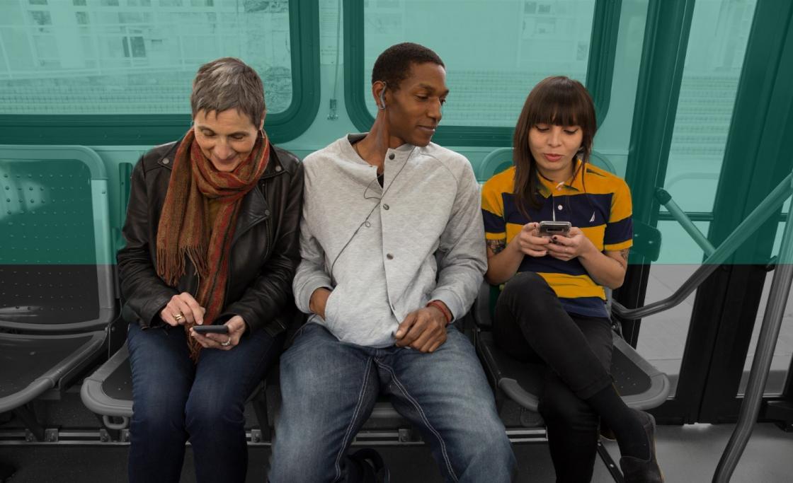 Three people sitting on the bus