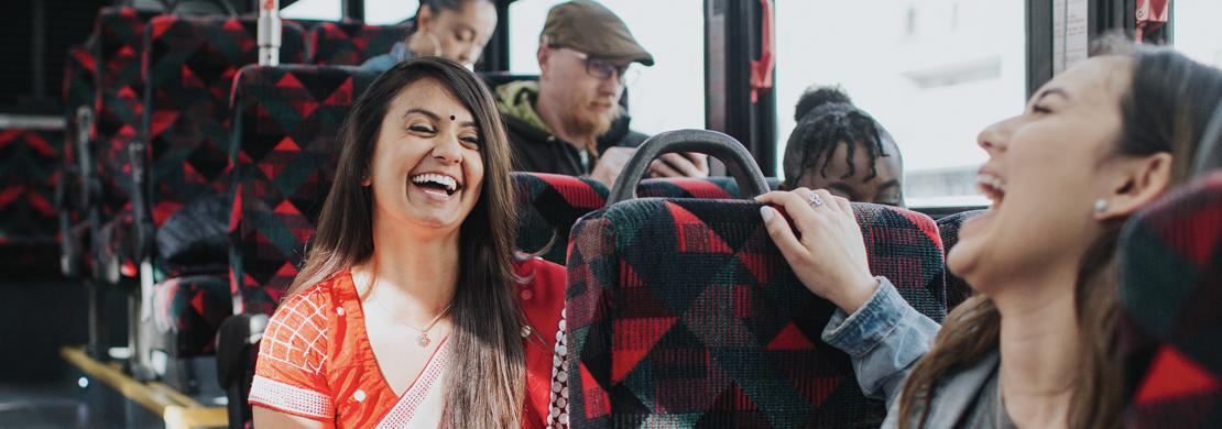Woman on the bus, laughing