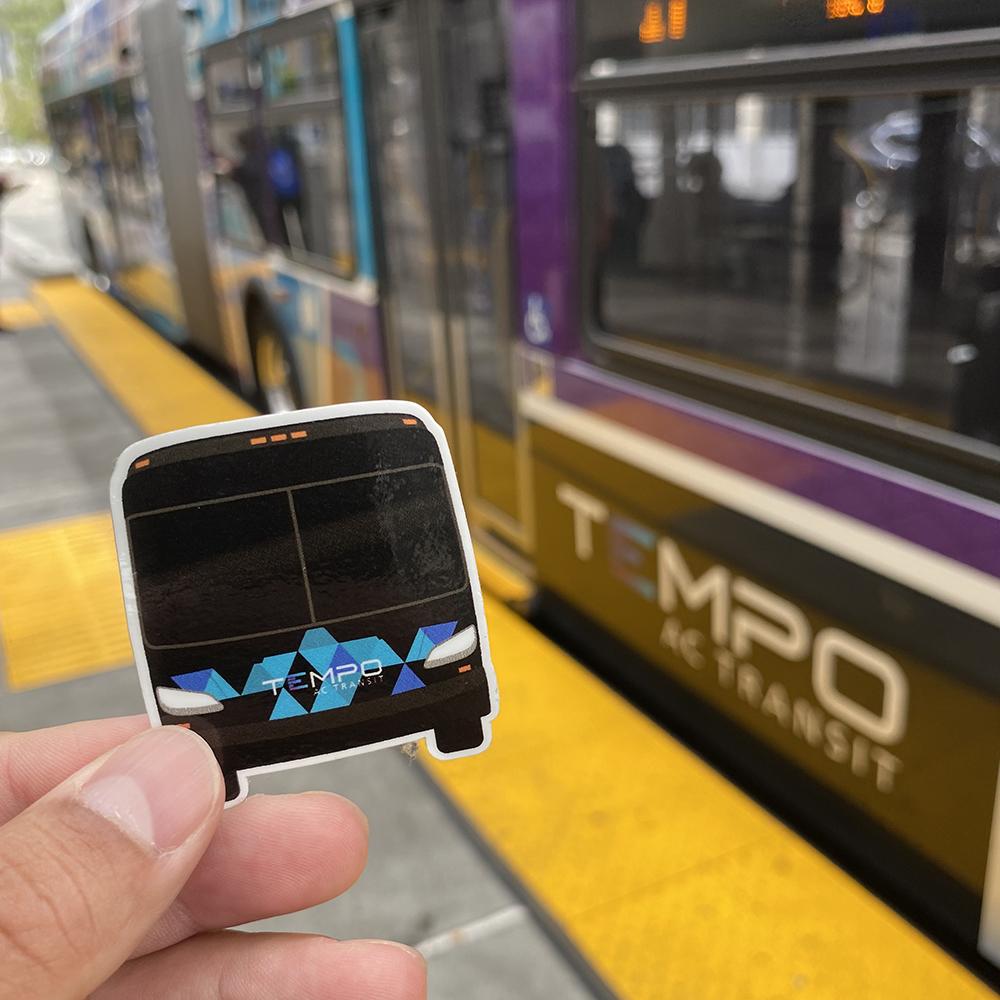 Tempo bus sticker being held on platform