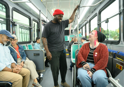 two riders speak on the bus